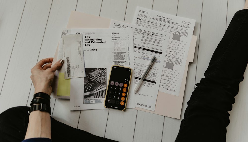 Calculator and documents arranged on a desk for tax preparation
